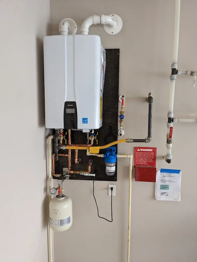 Professional plumber installing copper piping in a Richwood home